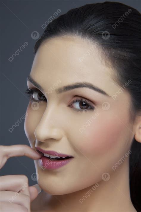 Portrait Of A Young Female Biting Her Fingernail Over Colored
