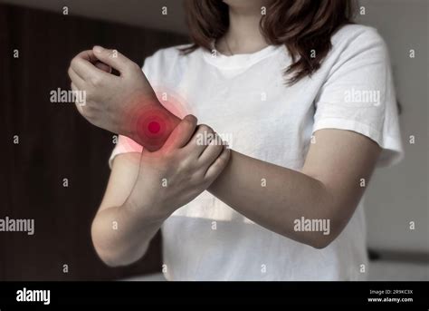 Inflammation at the wrist joint of Asian young woman. Concept of joint ...