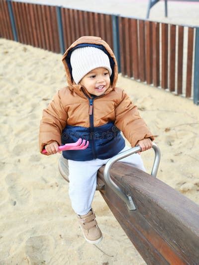 happy toddler boy  winter clothes playing    stock image