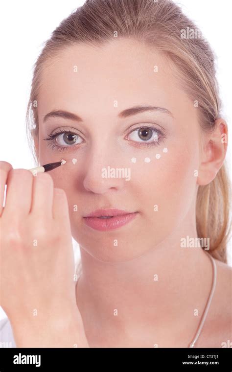 young beautiful woman applying concealer on face isolated Stock Photo ...