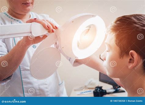 Concentrated Dermatologist Using Medical Loupe in the Clinic Stock ...