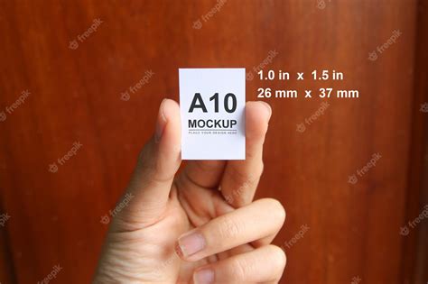 Premium PSD | Hand holding a10 paper mockup simple clean modern ...