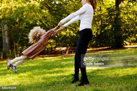 woman swinging child stock  high res pictures  images