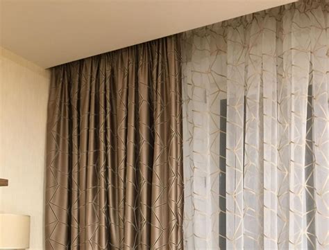 the curtains are pulled back to let light into the room, while the lamp ...