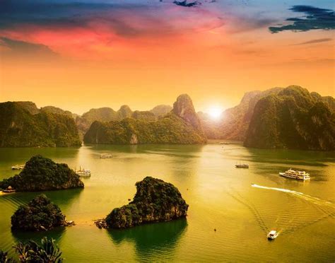 an aerial view of the bay and mountains at sunset, with boats in the water