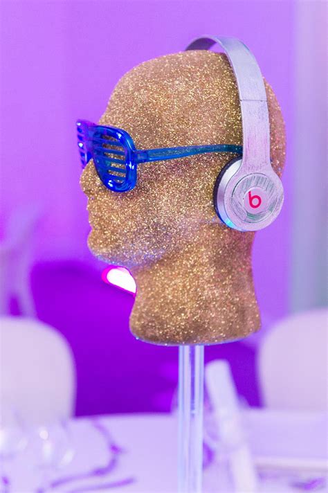 DJ centrepiece with glitter head, headphones and shades on LED base