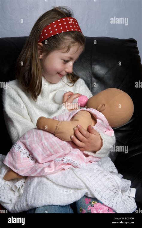 Girl feeding bady doll hi-res stock photography and images - Alamy