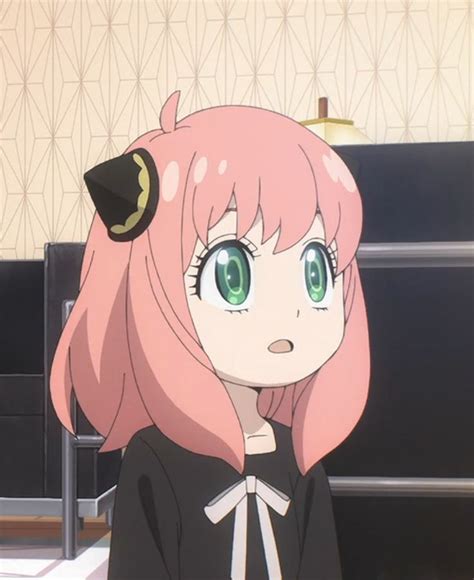 an anime girl with pink hair and green eyes wearing a black dress in a room