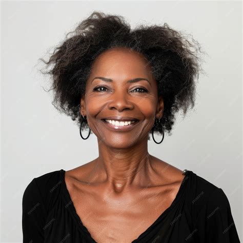 Stunning mid aged mature Black woman with a radiant smile gazing at the