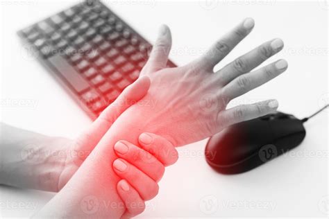 Woman working in office with a carpal tunnel syndrome or wrist joint