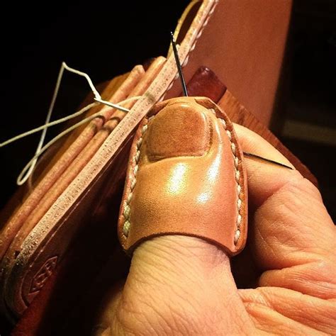 A hardened leather thimble to make stitching leather easier ...