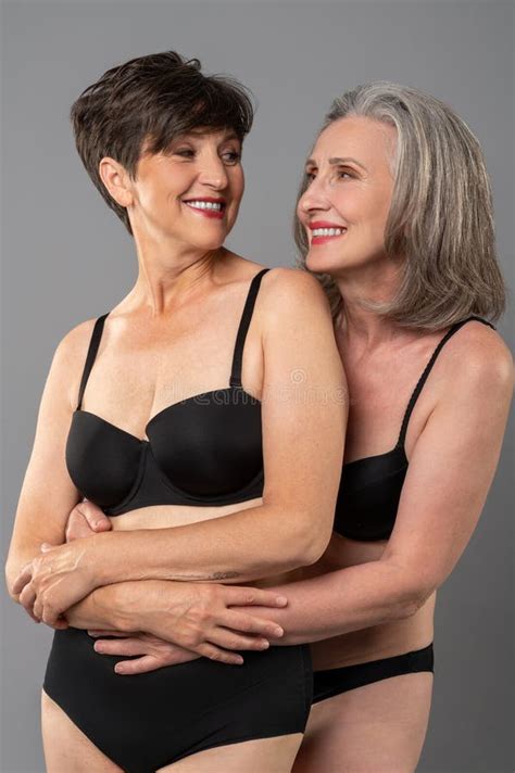 senior woman  black lingerie feeling good  smiling stock photo