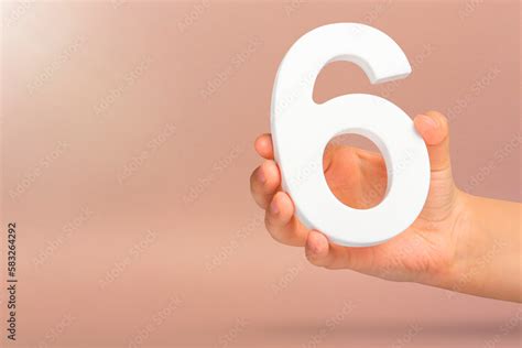number   hand  hand holds  white number    red background