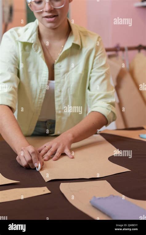 vertical photo   woman cutting  pieces  clothing   sewing