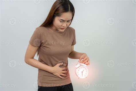 Asian women have stomach ache. Stomach ache due to eating irregularly
