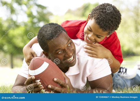 Father Football Player Lights A Cake With Soccer Candles With Children ...