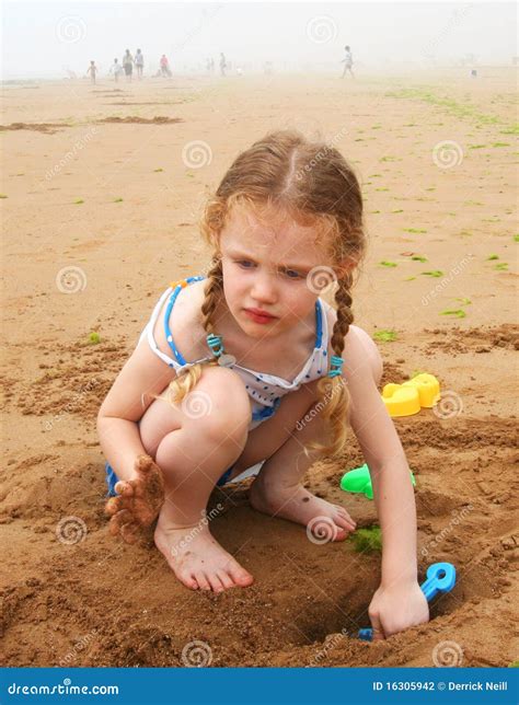 Digging at the Beach stock photo. Image of polkadots - 16305942