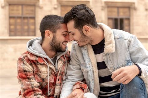 Premium Photo | Gay couple nuzzling nose to nose outdoors