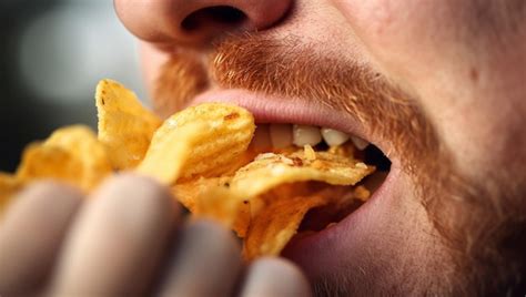 premium photo person eating delicious potato chips close   mouth