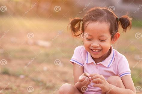 A Cute Little Girl Smiling and Laughing Happily in the Evening with ...