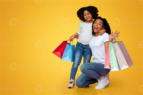 Shopping Fun. Overjoyed Afro Woman And Her Little Daughter Posing With