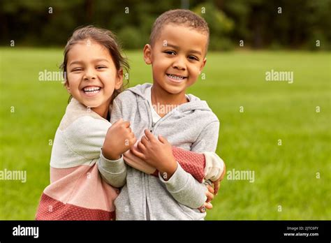 happy little boy and girl hugging at park Stock Photo - Alamy