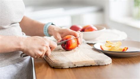 woman cutting peach stock photo image  dessert aroma