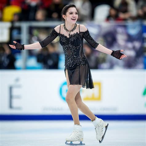 a female figure skating on an ice rink